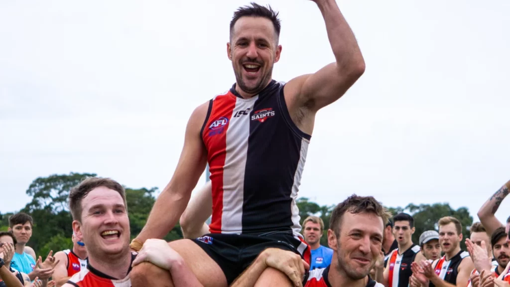 This exec loves playing Aussie rules football, broken bones and all